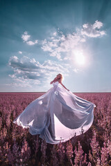 Beautiful woman in pink field