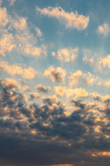 sun sets behind the clouds in the blue evening sky as a natural background