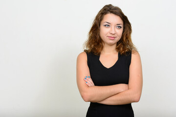 Fototapeta premium Portrait of young beautiful woman thinking with arms crossed