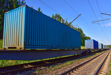 Obraz premium Cargo Containers Transportation On Freight Train By Railway. Intermodal Container On Train Car. Rail Freight Shipping Logistics. Import - export goods from Сhina. Soft focus, possible granularity