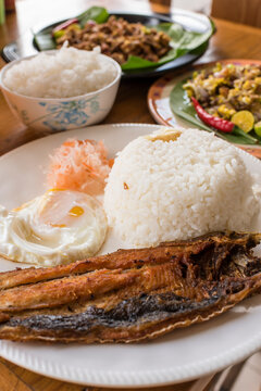 Closeup of Bangsilog with atchara, plus Pork Sisig. Example of Filipino cuisine.