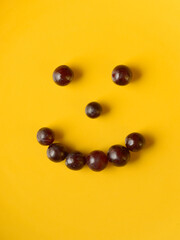 Portrait of smiley face made of grapes