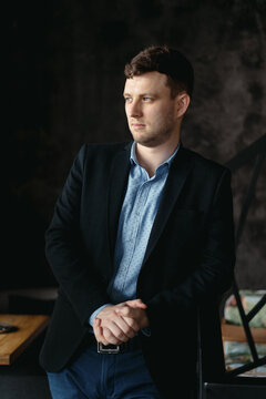 Executive manager portrait looking at camera standing in modern loft space.