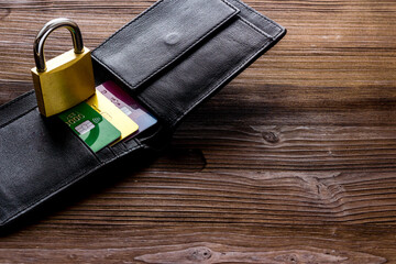 Credit card security concept with lock, wallet on wooden desk copy space