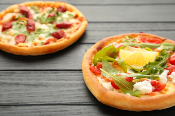 Delicious italian pizzas on black wooden table