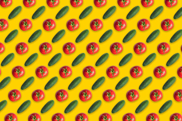 Colorful pattern of red tomatoes and cucumbers on a yellow background. The view from the top