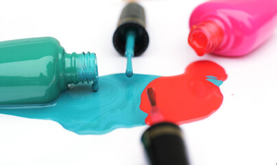 Fototapeta premium Spilled Nail Polish on White Background Pink and Green