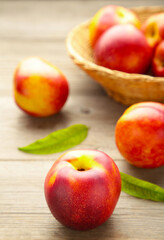 Nectarines in a basket on grey background with copy space