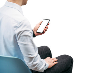 A business man in a shirt holds a phone with a white screen on a white background.  Photo with a place for an inscription. Photo for the designer. Isolate the photo. Smart watch on the hand..