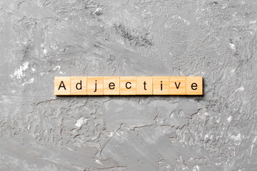 adjective word written on wood block. adjective text on cement table for your desing, concept