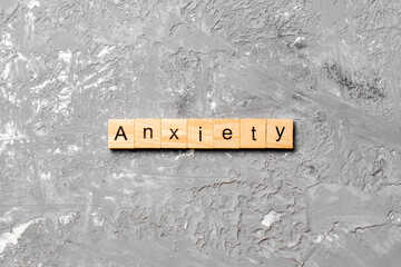 ANXIETY word written on wood block. ANXIETY text on table, concept
