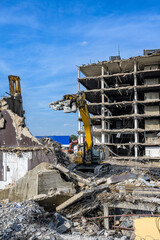 Building House Demolition site Excavator with hydraulic crasher machine and yellow container