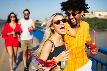 Group of happy friends people having fun together outdoors