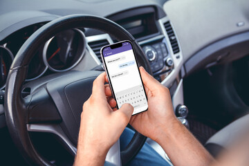 A man driving a car with  phone