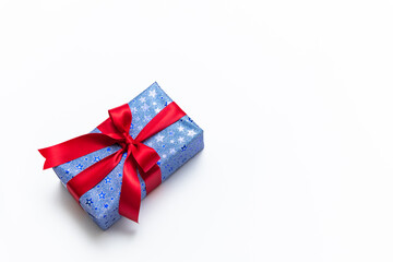 Blue gift box with red ribbons isolated on white background