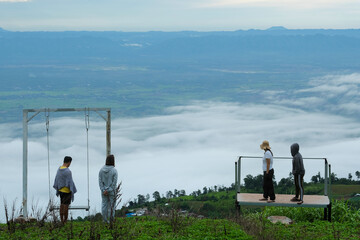 Fototapeta na wymiar June 26 2020 : The tourist standing at the viewpoint and enjoying beautifull foggy landscape at Phu Tab Burk, Phet cha Boon province, Thailand.
