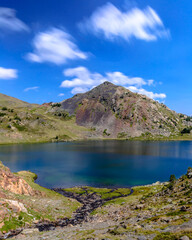 Naklejka premium A blue water lake in the Pyrenees Mountains. (Capcir, France, the route of the Bouillouses Lakes, near the Massif of Carlit)