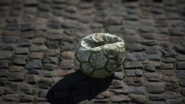 Old soccer ball in the pavement yard