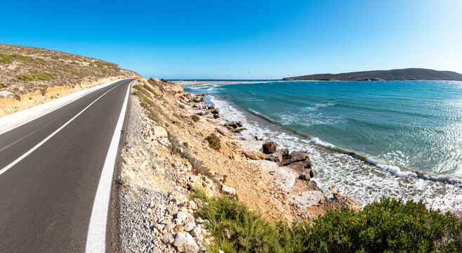 Coastline road to Prasonisi beach with kite surfers in background (Rhodes, Greece)