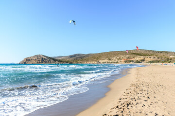 Prasonisi beach with kitesurfers surfing in waves (Rhodes, Greece)