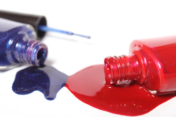 Red, White and Blue Nail Polish Spilled on White Background