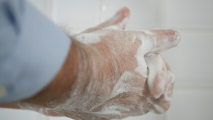Fototapeta premium Person Washing His Hands with Soap and Water, Cleans and Disinfect Against Viruses and Diseases