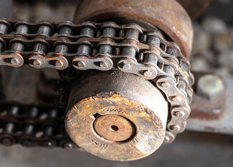 A metal chain on a motor as a backdrop.