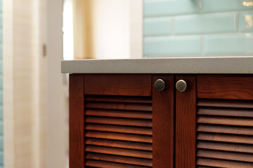 Modern bathroom interior details with wooden furniture and mint tile walls