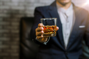 Closeup businessmen holding a glass of whiskey