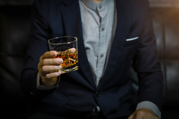 Closeup businessmen holding a glass of whiskey