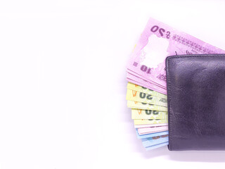 Closeup view of  black wallet full of Bangladeshi bank notes.