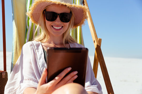 Woman using digital tablet at the beach