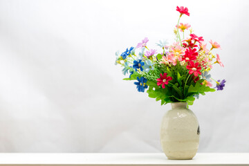 bunch of plastic flowers in vase