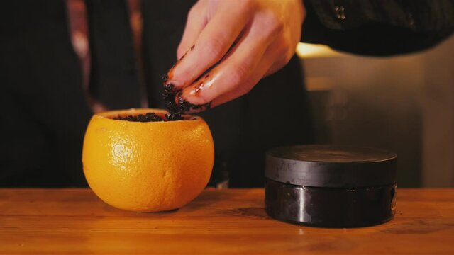 Hookah master makes a hookah from grapefruit. Fragrant Hookah