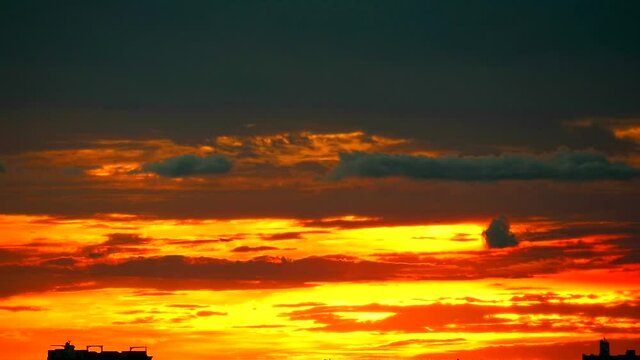 cargo ship slow moving on sea and sunset red orange colud on sky