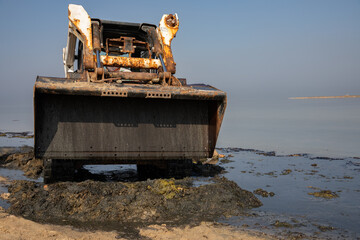 bobcat, works to clean the beach, Skid loader