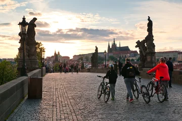 Fotobehang Locals casually walking down Charles bridge and enjoying the relaxed atmosphere during a lockdown in Prague © Gabriel