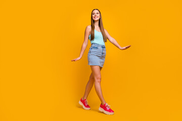 Full length body size view of her she nice-looking attractive lovely cheerful cheery straight-haired girl going enjoying summertime isolated over bright vivid shine vibrant yellow color background