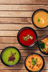 flat lay of cream vegetable soups on wooden table