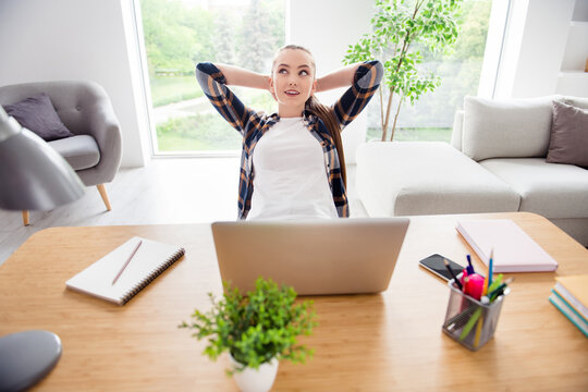 Photo Of Beautiful Lady Minded Student Browsing Notebook Sit Table Education Concept Look Dreamy Up Hands Behind Head Clever Intelligent Girl Social Distance Stay Home Working Indoors