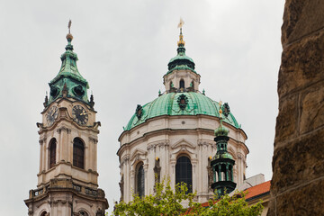 Fototapeta na wymiar Framed view of St. Nicholas church from Malostranske square