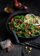 Summer salad with strawberry and soft cheese 
