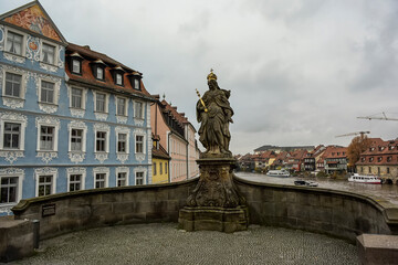 Fototapeta na wymiar Statue of St. Kunigunde of Luxembourg on Untere Brucke bridge over river Regnitz, Bamberg, Germany. November 2014