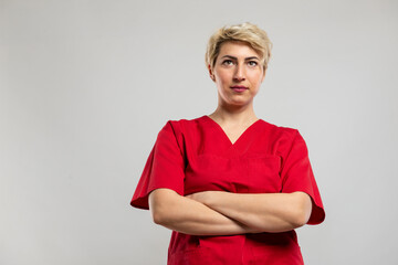 Low angle of attractive female nurse standing with arms crossed