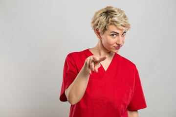 Portrait of young attractive female nurse making watching you