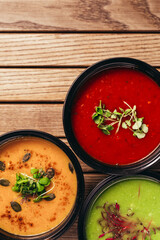 flat lay of cream vegetable soups on wooden table