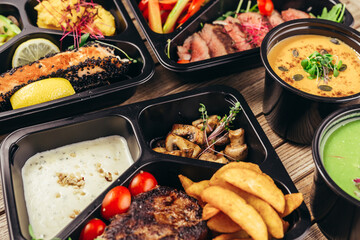 group of food in plastic dish on table. take away food