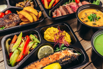 group of food in plastic dish on table. take away food