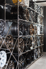 wall of alloy wheels in the store. Auto repair shop background. Auto Wheel Service.