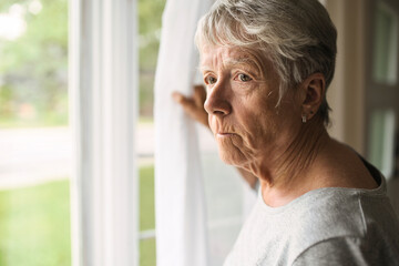 A worried senior woman at home felling very bad